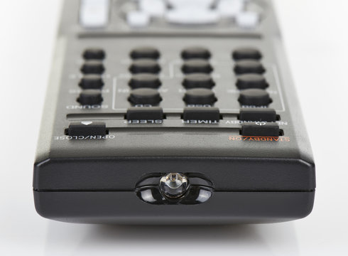 Remote control keypad black in closeup on white isolated