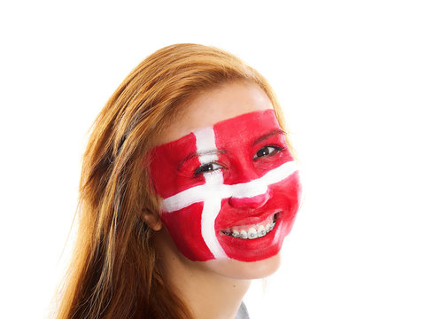 smiling girl with danish flag painted on her face