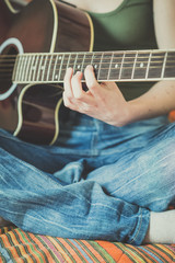 Fototapeta premium close up of woman hands playing guitar