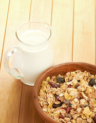 Plate with raw oatmeal on wooden table.