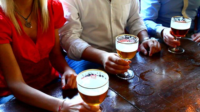 Four friends with a fresh beer 