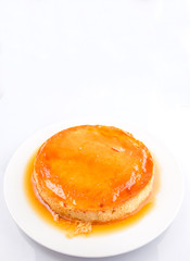 Caramel pudding on a white plate