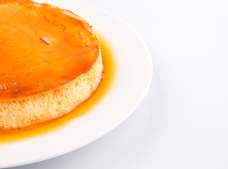 Caramel pudding on a white plate
