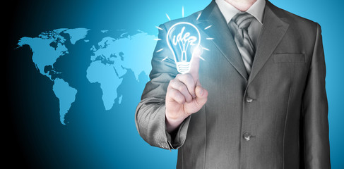 Business man touching light of idea