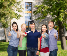 group of students with diploma showing thumbs up