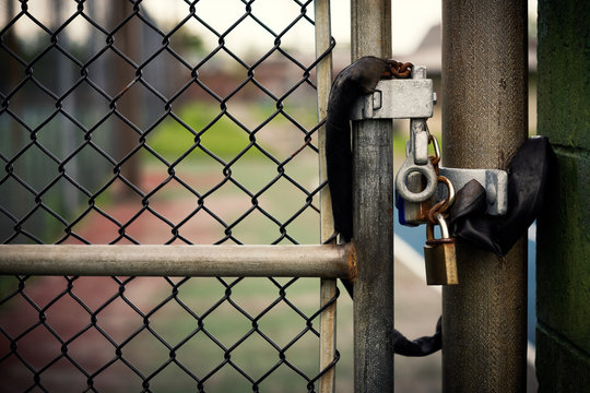 Padlocks on a Chain-link Gate - Powered by Adobe