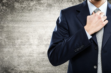 Businessman adjusting his necktie