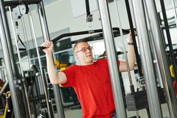 Fototapeta na wymiar man doing back exercises at fitness gym