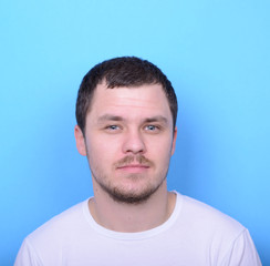 Obraz premium Portrait of handsome man in casual clothes against blue backgrou