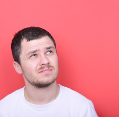 Fototapeta premium Portrait of man thinking against red background