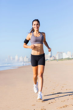 healthy young woman running on beach