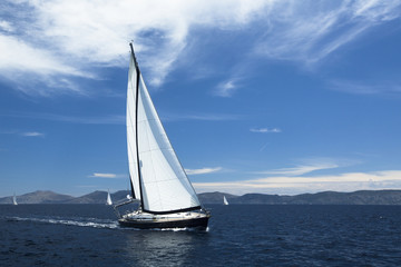 Sailing ship yachts with white sails.