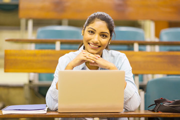 cute indian college student in lecture room