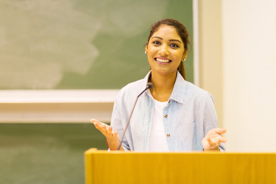 female college student giving a speech to lecture hall Photos | Adobe Stock