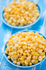 Sweet corn kernels, blue wooden background, studio shot