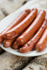 Close-up of grilled sausages on a plate, vertical shot