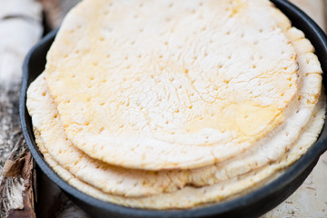 Close-up of corn tortillas in a frying pan, studio shot