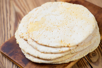 Mexican corn tortillas over wooden background, horizontal shot