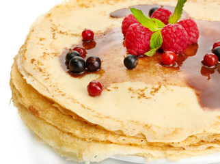 Delicious pancakes with berries and chocolate