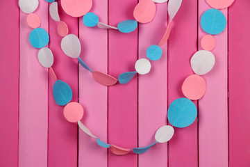 Decorative felt garland on wooden background © Africa Studio