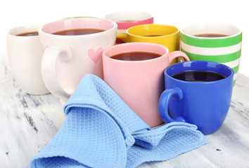 Many cups of coffee on wooden table close up