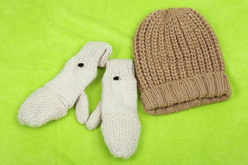 Winter cap and gloves,  on color background