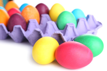 Colorful Easter eggs in tray isolated on white