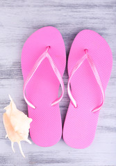 Bright flip-flops on color wooden background