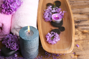Composition with spa treatment, wooden bowl with water, towel