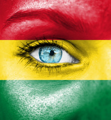 Woman face painted with flag of Bolivia