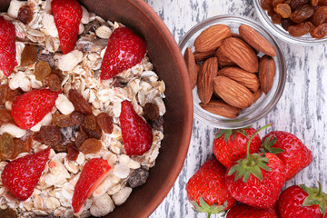 Healthy cereal with strawberry on wooden table