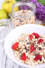 Healthy cereal with fruits on wooden table