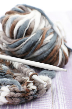 Knitting with spokes on wooden background