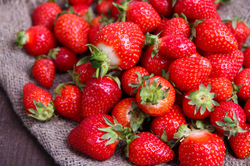 Ripe sweet strawberries on sackcloth  background