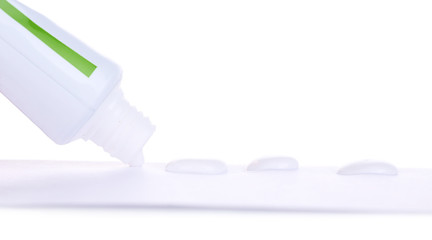 Toothpaste squeezed from tube, close-up, isolated on white