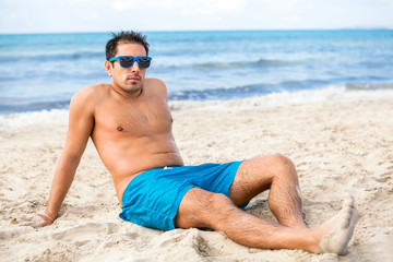 Handsome man relaxing on the beach