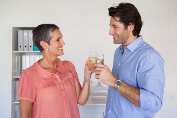 Casual successful business team toasting with champagne