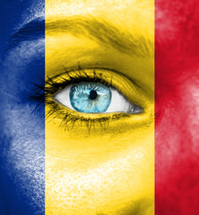 Woman face painted with flag of Romania
