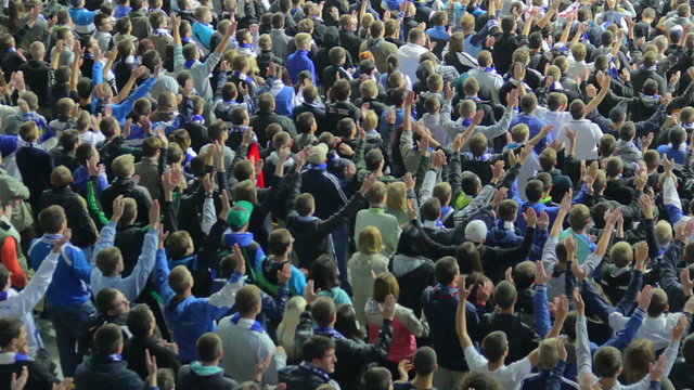 Clapping football fans, raising hand in air, match game stadium