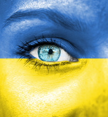 Woman face painted with flag of Ukraine