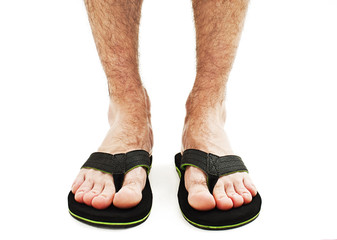 Male foot in flip-flop. Isolated on white background