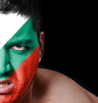 Portrait of angry man with painted flag of Bulgaria