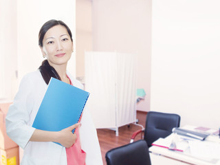 Portrait of young asian smiling doctor at clinic