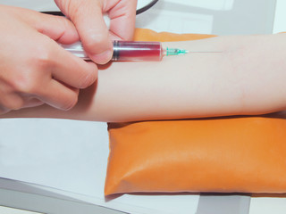 Portrait of woman nurse hand making injection in cllinic