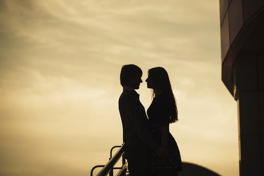 Couple in love silhouette during sunset - touching noses