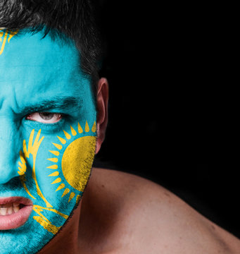 Portrait of angry man with painted flag of Kazakhstan