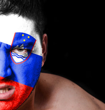 Portrait of angry man with painted flag of Slovenia