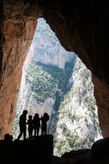 Silhouette children in a Colomera cave, Montsec mountain, Spain