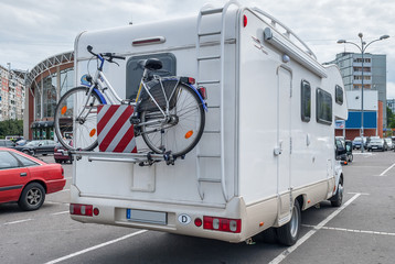 camper with bicycle in city