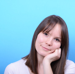 Fototapeta premium Portrait of beautiful happy woman against blue background
